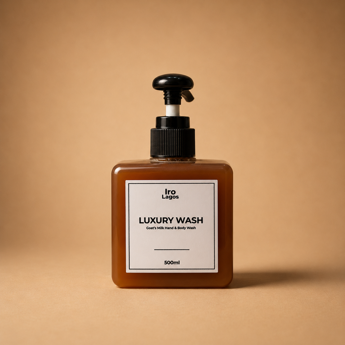 A 500ml bottle of Iro Lagos Luxury Wash hand and body wash, featuring a square amber-brown translucent bottle, a black pump dispenser, and a minimalist white label.